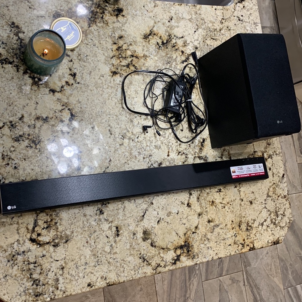 black LG sound bar and subwoofer